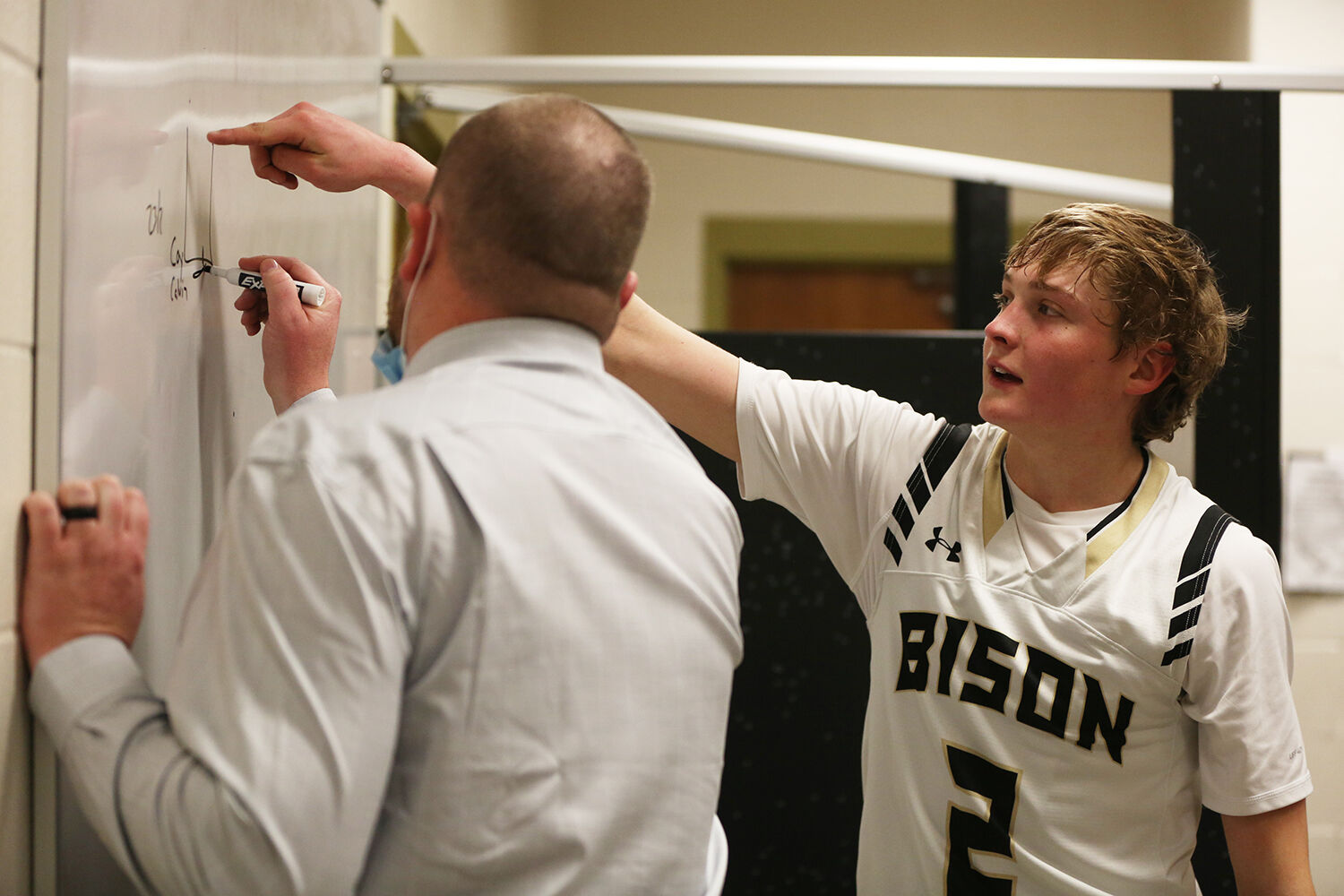 Coy Johnson asks head coach Tanner Hart a question about a play